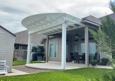 white alumawood pergola attached to house in the backyard
